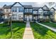 Charming townhome exterior showcasing blue trim, inviting walkway, and well-maintained landscaping at 2357 Central Ave, Indianapolis, IN 46205
