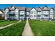 Inviting townhouse complex featuring well-maintained lawns and charming curb appeal with a sidewalk at 2357 Central Ave, Indianapolis, IN 46205