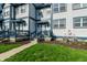 Charming townhouse with blue trim, a small porch, well-kept lawn, and modern air conditioning units at 2357 Central Ave, Indianapolis, IN 46205