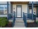 Inviting front porch with blue trim and steps leading to the entrance door with house number at 2357 Central Ave, Indianapolis, IN 46205