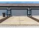 Spacious three-car garage with white doors, exterior lights, and a concrete driveway for easy parking at 2357 Central Ave, Indianapolis, IN 46205