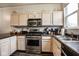 A well-lit kitchen with light wood cabinets and stainless steel appliances at 2357 Central Ave, Indianapolis, IN 46205