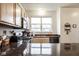 Modern kitchen with dark countertops, stainless steel appliances, and light wood cabinets at 2357 Central Ave, Indianapolis, IN 46205