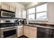 This kitchen offers bright light, stainless steel appliances, and light wood cabinets at 2357 Central Ave, Indianapolis, IN 46205