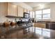 Bright kitchen featuring stainless steel appliances, light wood cabinets, and dark countertops at 2357 Central Ave, Indianapolis, IN 46205