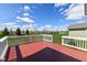 Spacious wooden deck showcasing scenic backyard views, complemented by vibrant green grass and blue skies at 2564 Tangleridge Ln, Brownsburg, IN 46112