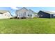 A well-maintained backyard view showcases a spacious lawn and a deck with multiple windows overlooking the yard at 2564 Tangleridge Ln, Brownsburg, IN 46112
