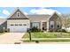 Charming single-Gathering home features a well-manicured lawn and an attached two-car garage at 2564 Tangleridge Ln, Brownsburg, IN 46112