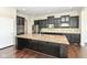 Gourmet kitchen features a large center island, stainless steel appliances, and dark wood cabinets at 2564 Tangleridge Ln, Brownsburg, IN 46112