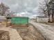 Backyard features a green covered patio and shed, adding character and functionality at 3049 Foltz St, Indianapolis, IN 46241