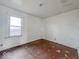 Empty bedroom featuring hardwood floors and a window with natural light at 3049 Foltz St, Indianapolis, IN 46241