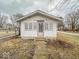 Small home featuring a simple entrance, a concrete walkway and neutral exterior paint at 3049 Foltz St, Indianapolis, IN 46241