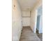 Hallway featuring laminate floors and a white storage cabinet at 3049 Foltz St, Indianapolis, IN 46241