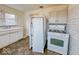 A kitchen features a large sink, tiled floors, a refrigerator and gas stove/oven combo at 3049 Foltz St, Indianapolis, IN 46241
