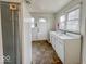 A kitchen features a large sink, tiled floors, and a door leading to the exterior at 3049 Foltz St, Indianapolis, IN 46241