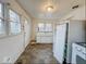 A kitchen features a large sink, tiled floors, a refrigerator and gas stove/oven combo with a window at 3049 Foltz St, Indianapolis, IN 46241