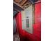 Basement electrical panel on a red brick wall with exposed wiring and a metal access door at 3829 N Temple Ave, Indianapolis, IN 46205