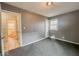 A sunlit bedroom provides ample space, complemented by an attached bathroom with tiled floors at 3829 N Temple Ave, Indianapolis, IN 46205