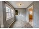 Bright dining room featuring textured walls, tiled floors, and large window at 3829 N Temple Ave, Indianapolis, IN 46205