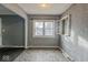 The dining room features tiled floors, textured walls and a window at 3829 N Temple Ave, Indianapolis, IN 46205