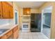 The kitchen area features wood cabinets, essential appliances, and tiled floors at 3829 N Temple Ave, Indianapolis, IN 46205
