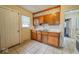 Functional kitchen featuring wood cabinets, tiled counters, and a double sink at 3829 N Temple Ave, Indianapolis, IN 46205