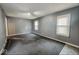 Spacious living room featuring neutral paint, carpet flooring, and bright windows at 3829 N Temple Ave, Indianapolis, IN 46205