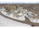 Aerial shot showcasing a neighborhood with townhouses and tree-lined streets covered in winter snow at 3986 Braddock Rd, Indianapolis, IN 46268