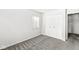 Cozy bedroom featuring carpeted floors, a double door closet, and natural light from a window at 3986 Braddock Rd, Indianapolis, IN 46268
