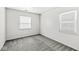 Well-lit bedroom with carpet, neutral paint, and two windows at 3986 Braddock Rd, Indianapolis, IN 46268
