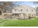 Two-story townhome featuring a brick facade, white siding, a fenced yard, and a well-maintained lawn at 3986 Braddock Rd, Indianapolis, IN 46268