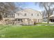 Two-story townhome featuring a brick facade, white siding, a fenced yard, and a well-maintained lawn at 3986 Braddock Rd, Indianapolis, IN 46268