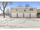Four-unit exterior featuring snow-covered ground, driveways, and garage doors at 3986 Braddock Rd, Indianapolis, IN 46268
