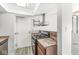 Kitchen featuring stainless steel oven, range hood, dark cabinetry, laminate countertops and wood-look flooring at 3986 Braddock Rd, Indianapolis, IN 46268
