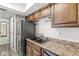 Kitchen featuring stainless steel appliances, dark cabinetry, laminate countertops and wood-look flooring at 3986 Braddock Rd, Indianapolis, IN 46268