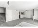 Spacious living room with neutral carpet, white walls, stairs, with lots of natural light and open floor plan at 3986 Braddock Rd, Indianapolis, IN 46268