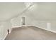 Spacious attic featuring neutral carpet, recessed lights, storage, and an open doorway to an adjacent area at 4029 Broadway St, Indianapolis, IN 46205