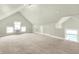 Spacious attic space featuring carpeting, updated paint, and natural light at 4029 Broadway St, Indianapolis, IN 46205
