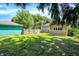 Backyard features green grass, wooden fence, garage, and the back of the home at 4029 Broadway St, Indianapolis, IN 46205