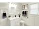 Bathroom featuring white vanity, gray towels, updated mirror and decorative wall art at 4029 Broadway St, Indianapolis, IN 46205