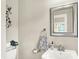 Bright bathroom featuring a pedestal sink, a mirror, and decorative accents at 4029 Broadway St, Indianapolis, IN 46205