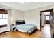 Cozy bedroom featuring wood floors, a comfortable bed, natural light, and classic wood trim at 4029 Broadway St, Indianapolis, IN 46205