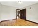 Bedroom featuring hardwood floors, neutral paint, wooden trim and doors at 4029 Broadway St, Indianapolis, IN 46205