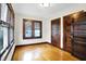 Bedroom featuring hardwood floors, neutral paint, wooden trim and doors at 4029 Broadway St, Indianapolis, IN 46205