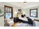 Stylishly furnished bedroom with a cozy chair, windows, and modern decor at 4029 Broadway St, Indianapolis, IN 46205