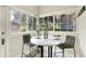 Bright breakfast nook with marble table and seating overlooking lush greenery at 4029 Broadway St, Indianapolis, IN 46205