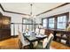 Elegant dining room boasts wainscoting, a modern chandelier, and ample natural light at 4029 Broadway St, Indianapolis, IN 46205