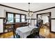 Well-lit dining area with built-in cabinetry, hardwood floors, and an adjacent living space at 4029 Broadway St, Indianapolis, IN 46205