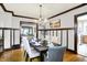 Stately dining room with ample seating and views into the living room and kitchen at 4029 Broadway St, Indianapolis, IN 46205