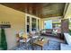 Charming front porch with hanging bench, stylish seating, and cozy ambiance at 4029 Broadway St, Indianapolis, IN 46205